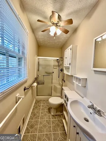 a bathroom with a sink toilet and shower