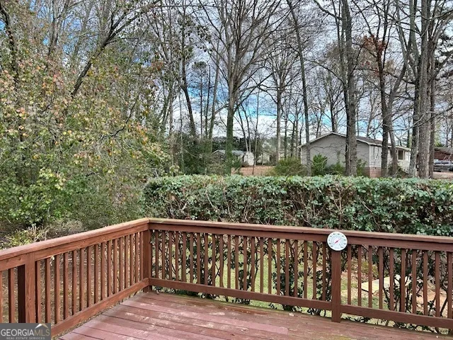 a balcony with wooden floor and fence
