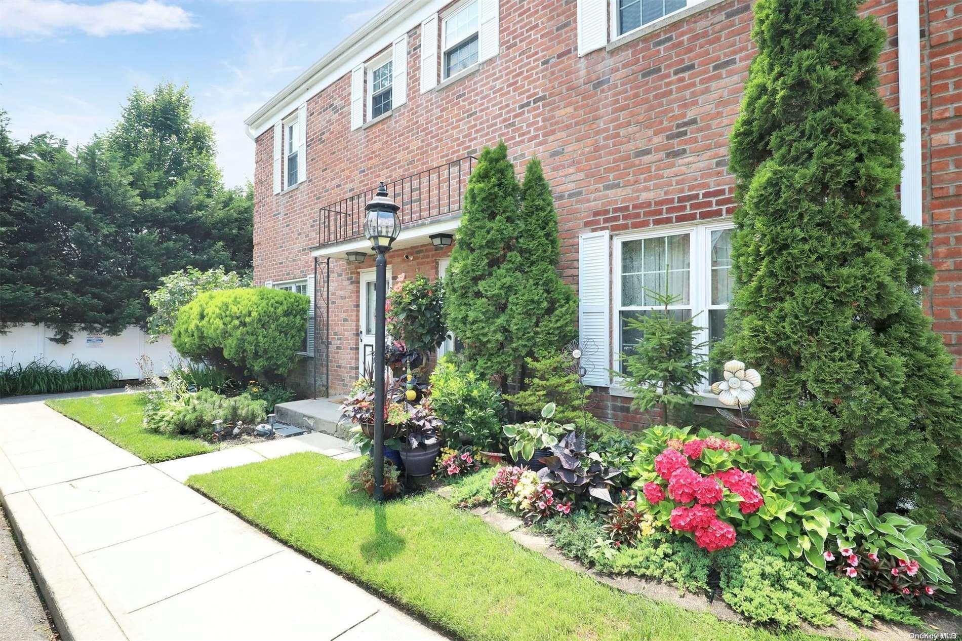 a view of a house with a yard and garden