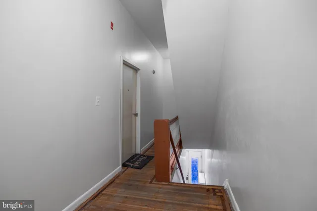 a kitchen with granite countertop a refrigerator a stove a sink dishwasher and white cabinets with wooden floor