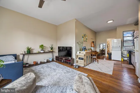 a view of storage and utility room with wooden floor