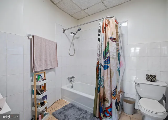a living room with furniture and a dining table