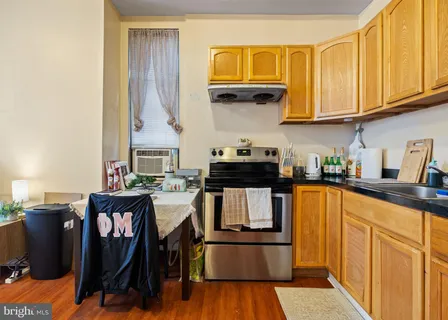 a kitchen view with microwave a stove and a refrigerator