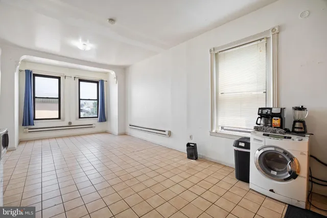 a kitchen with a stove top oven cabinets and a refrigerator