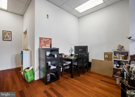 a view of a workspace with furniture and wooden floor