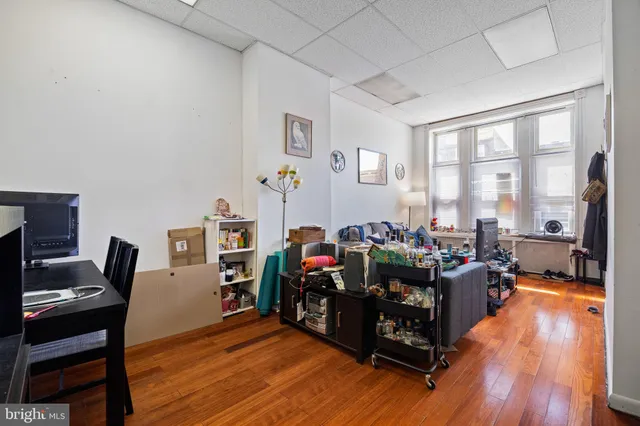 a living room with lots of furniture and wooden floor