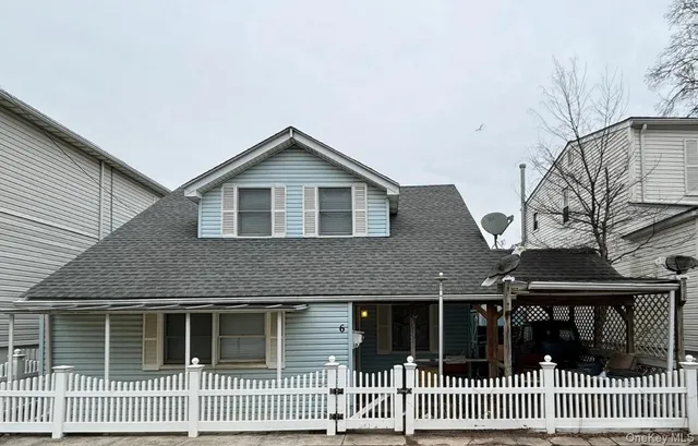 a front view of a house with iron fence