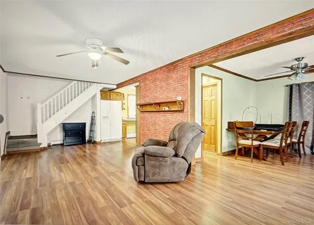 a living room with furniture a fireplace and wooden floor