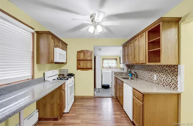 a kitchen with a stove a sink and a refrigerator