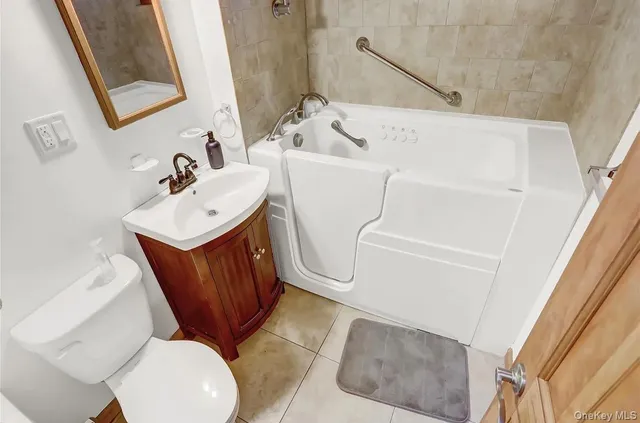 a bathroom with a sink toilet and mirror