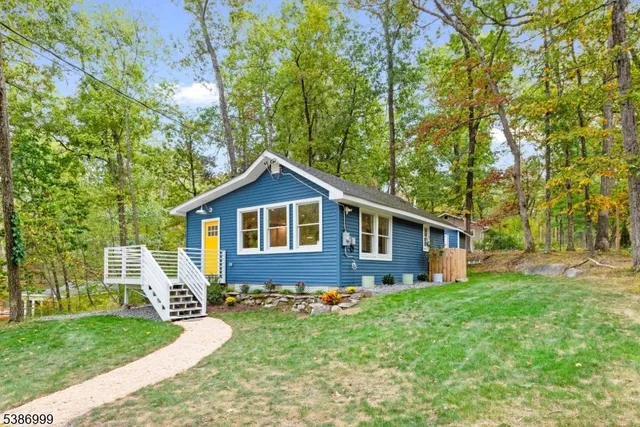 a front view of house with yard and green space