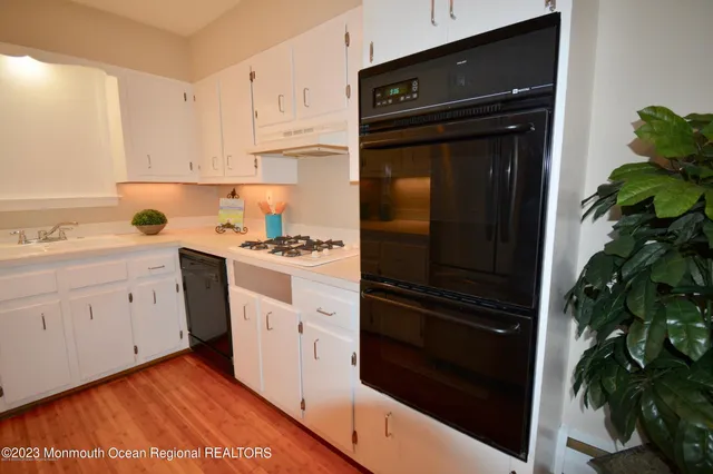 a white toilet sitting next to a bathroom sink and tub