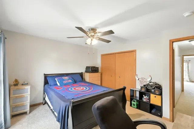 a living room with furniture and a ceiling fan