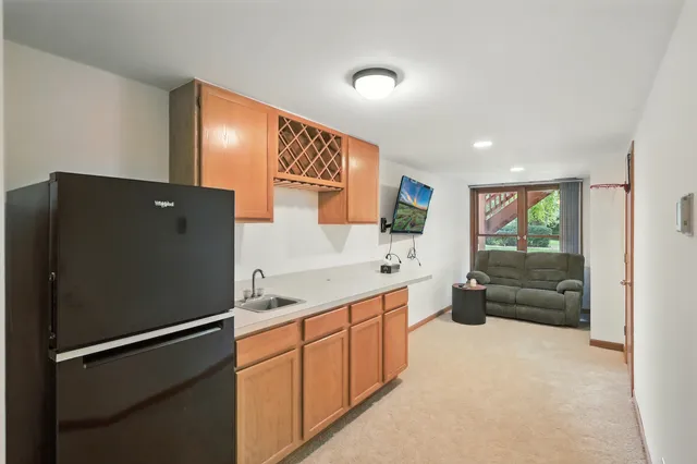 a kitchen with stainless steel appliances granite countertop a refrigerator and a sink