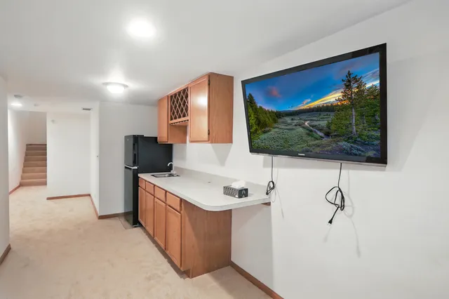 a kitchen with a cabinets and a flat screen tv