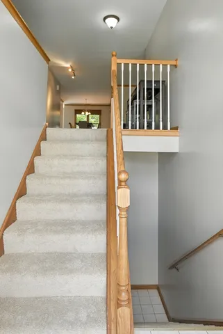 a view of staircase with white walls and windows