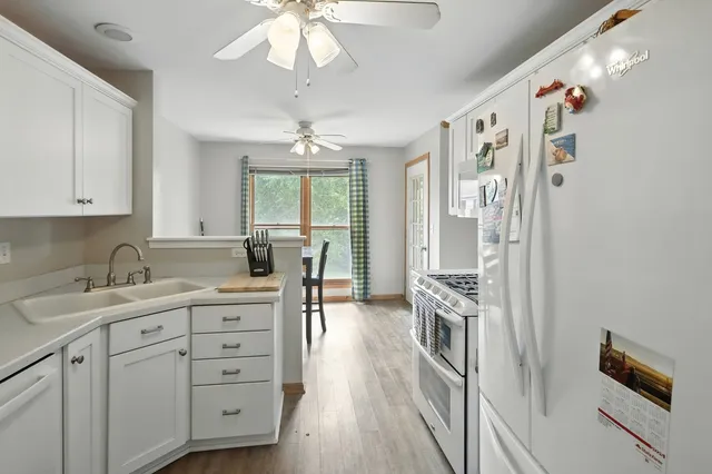 a kitchen with a sink stove and refrigerator