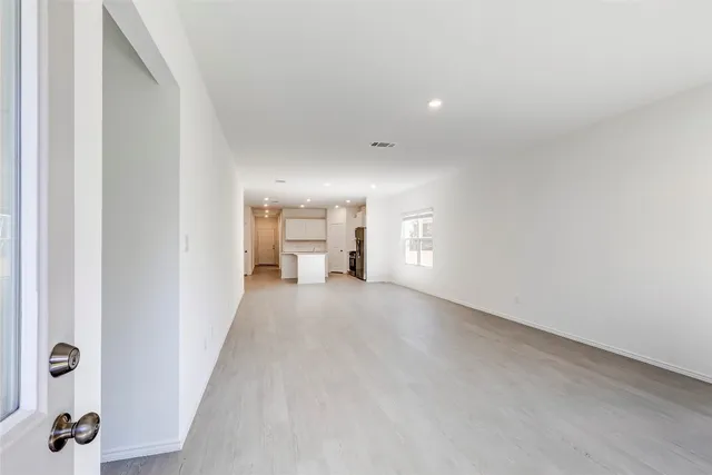 a view of a hallway with wooden floor