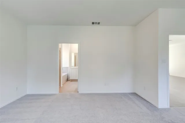a view of an empty room and a window