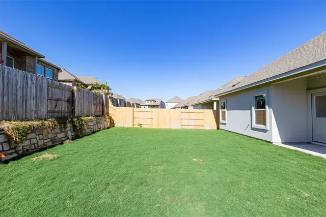 a view of a back yard of the house