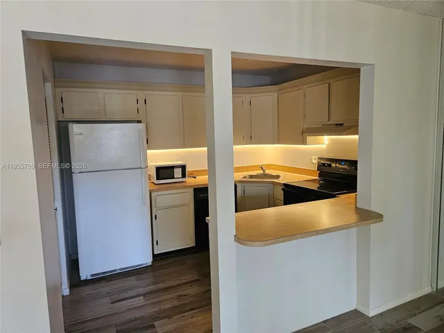 a kitchen with a refrigerator and a stove