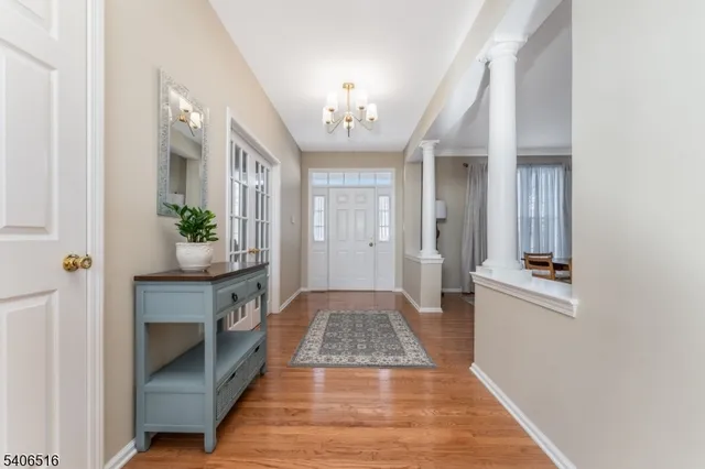 a view of a hallway view with wooden floor and staircase