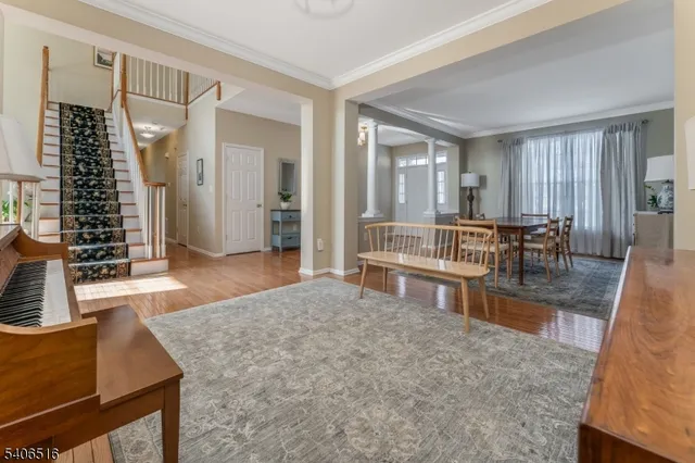 a living room with furniture a dining table and a large window