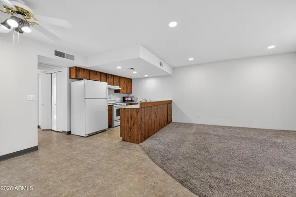 a view of kitchen and refrigerator
