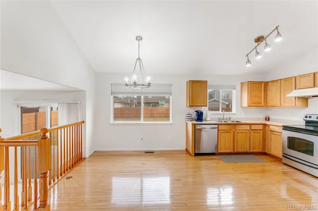 a view of a kitchen with a sink dishwasher and wooden floor