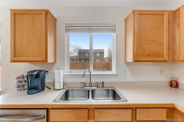 a kitchen with stainless steel appliances granite countertop a sink and a wooden cabinets