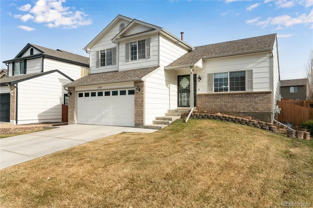 a front view of a house with a yard