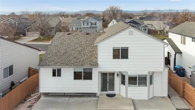 a view of a white house with large windows