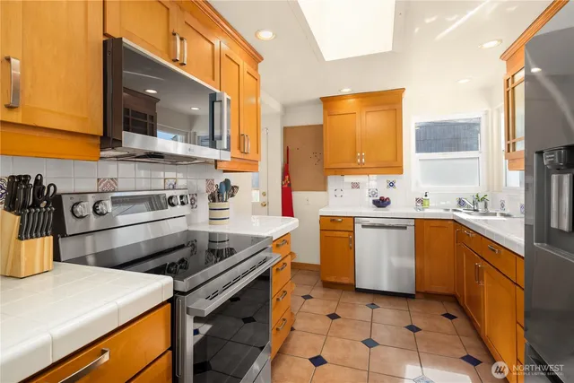 a kitchen with a sink stove and microwave