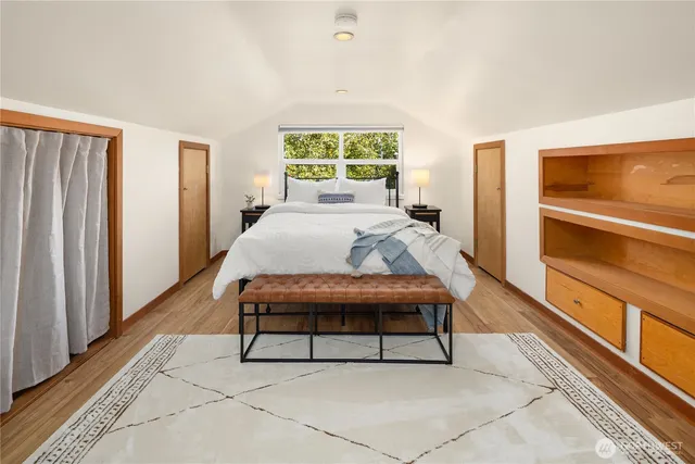 a living room with a bed furniture and a window