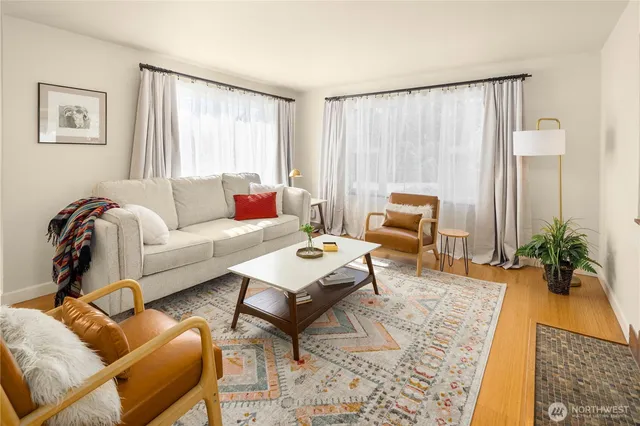 a living room with furniture and wooden floor