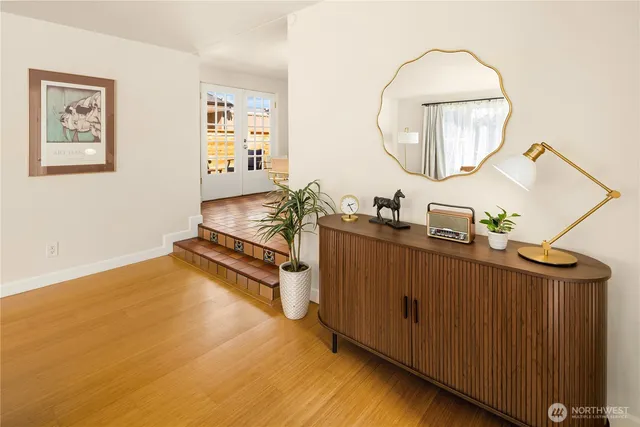 a room with wooden floor and mirror