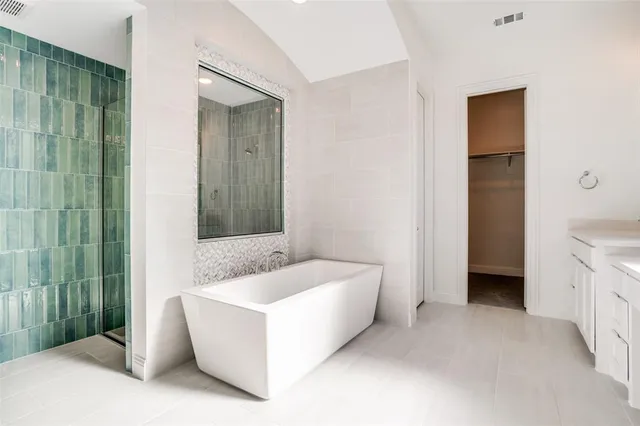 a spacious bathroom with a bathtub and a sink