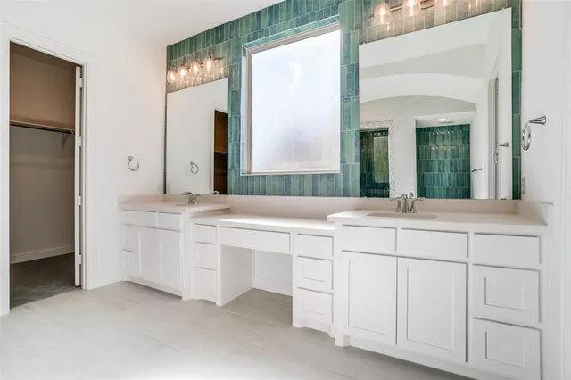 a bathroom with double sink and a mirror