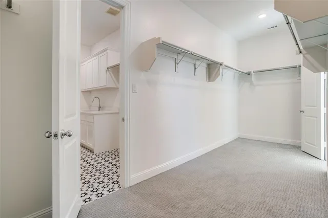 a view of empty room with cabinet and entryway