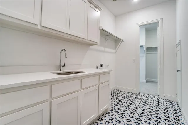 a kitchen with a sink and cabinets