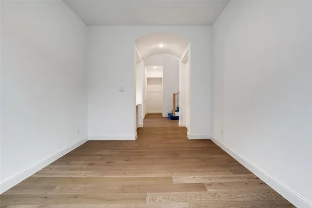 a view of a room with wooden floor and a bathroom