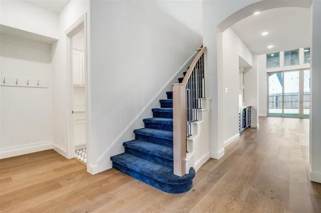a view of entryway and hall with wooden floor
