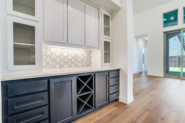 a kitchen with stainless steel appliances cabinets and wooden floor