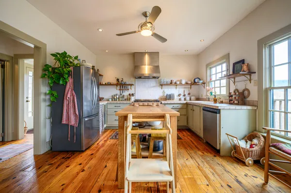 a kitchen with stainless steel appliances granite countertop a stove and a refrigerator