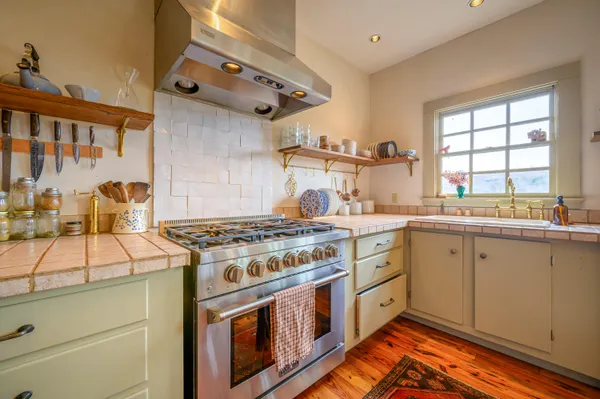 a kitchen with a stove a sink and a refrigerator