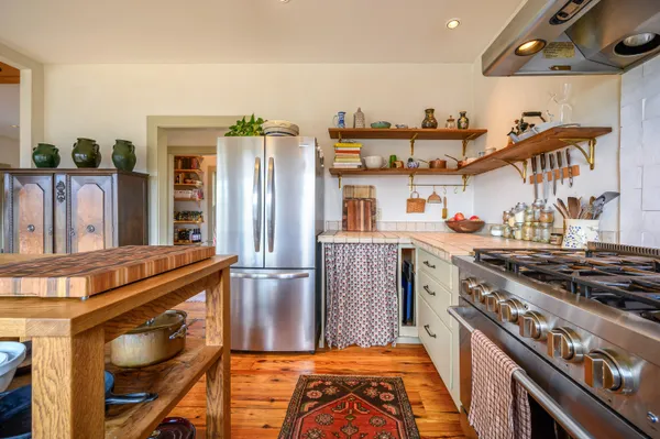 a kitchen with stainless steel appliances a refrigerator and a stove
