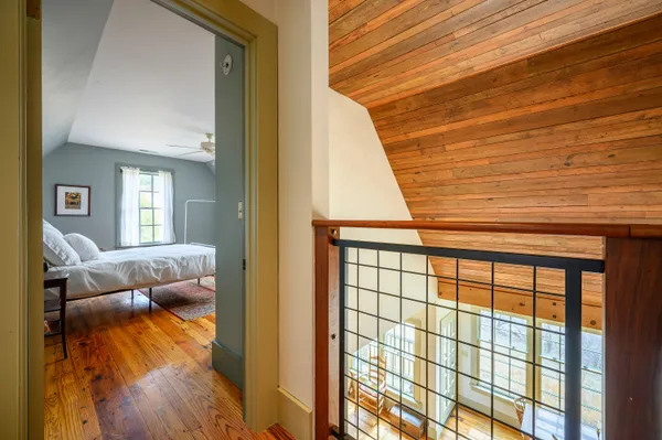 a view of a balcony with floor to ceiling windows with wooden floor