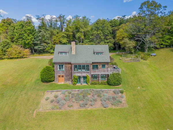 an aerial view of a house with a garden and swimming pool