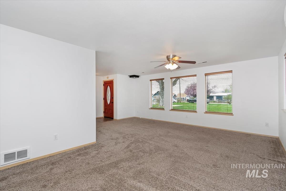 1051 Haas Road Weiser, ID 83672 - Photo 7 of 44 Empty room featuring carpet floors and a ceiling fan