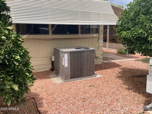 a view of living room with patio furniture and floor to ceiling window